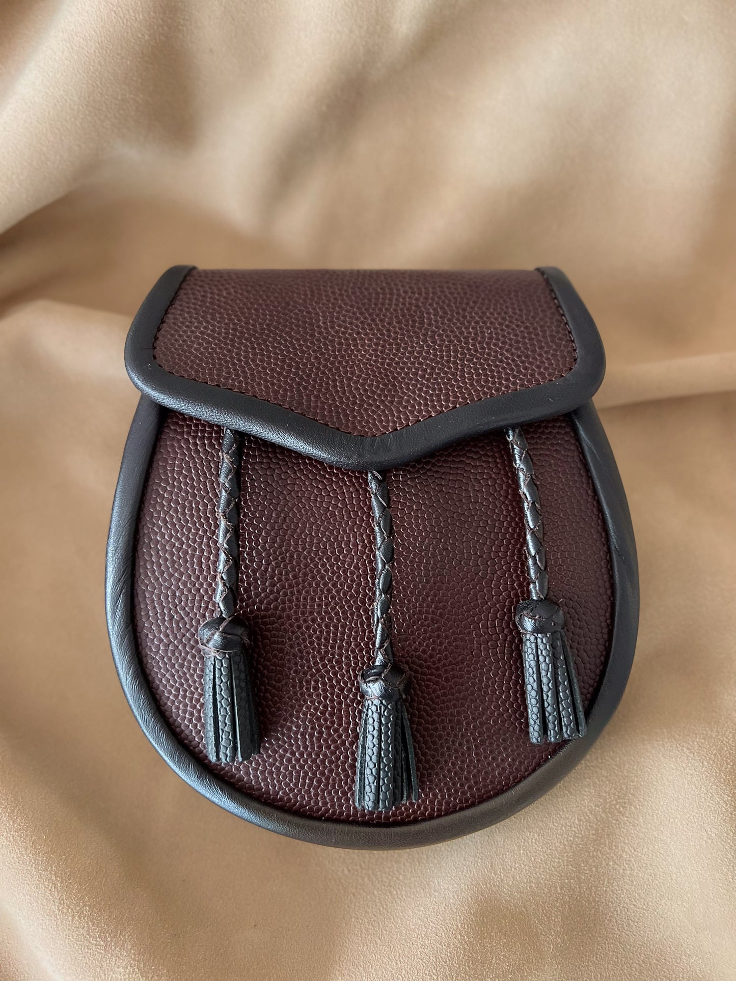 Brown pebbled leather sporran with black leather tassels