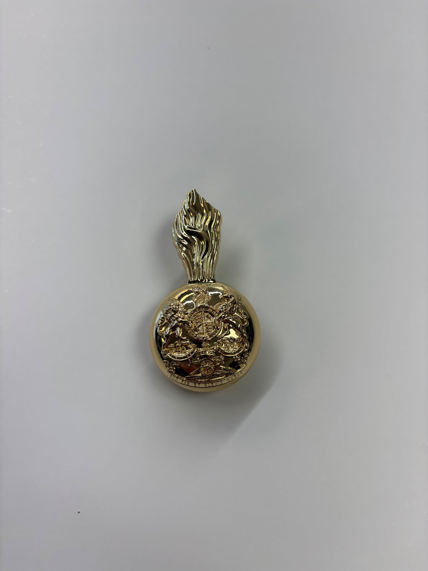 Gold badge with clip to hold plume
