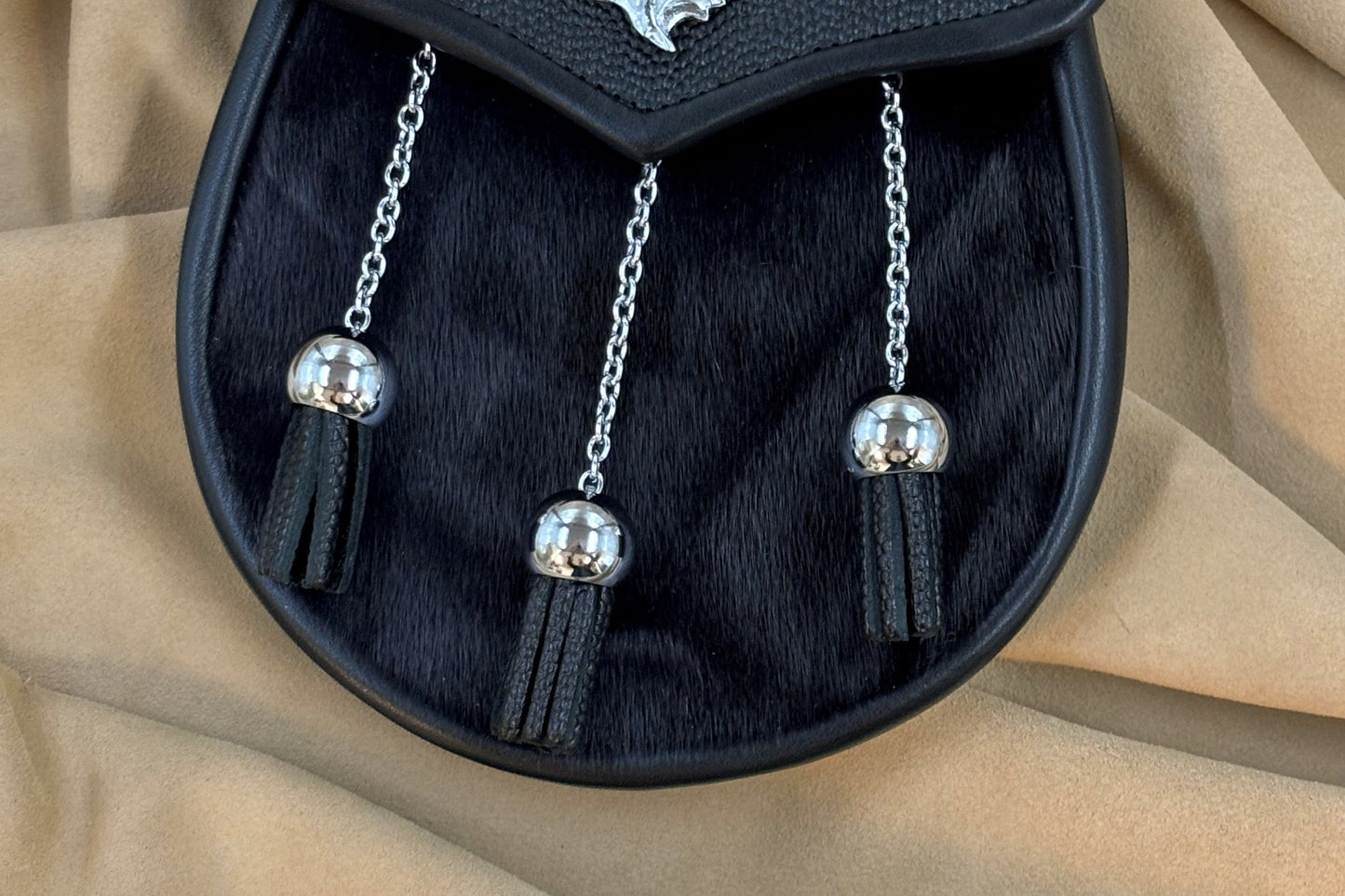 Black pebbled leather and seal sporran with nickel thistle hardware