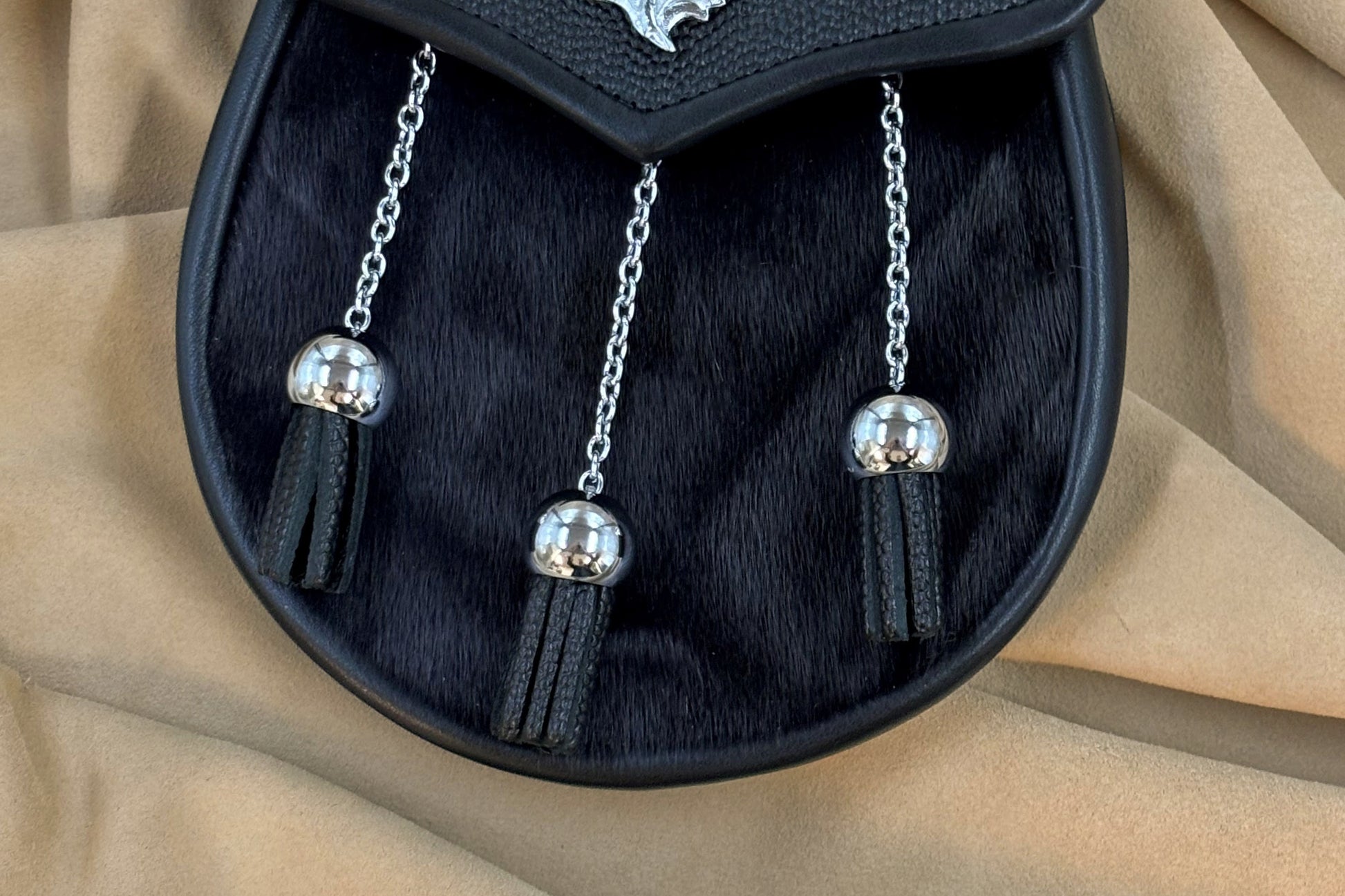 Black pebbled leather and seal sporran with nickel thistle hardware