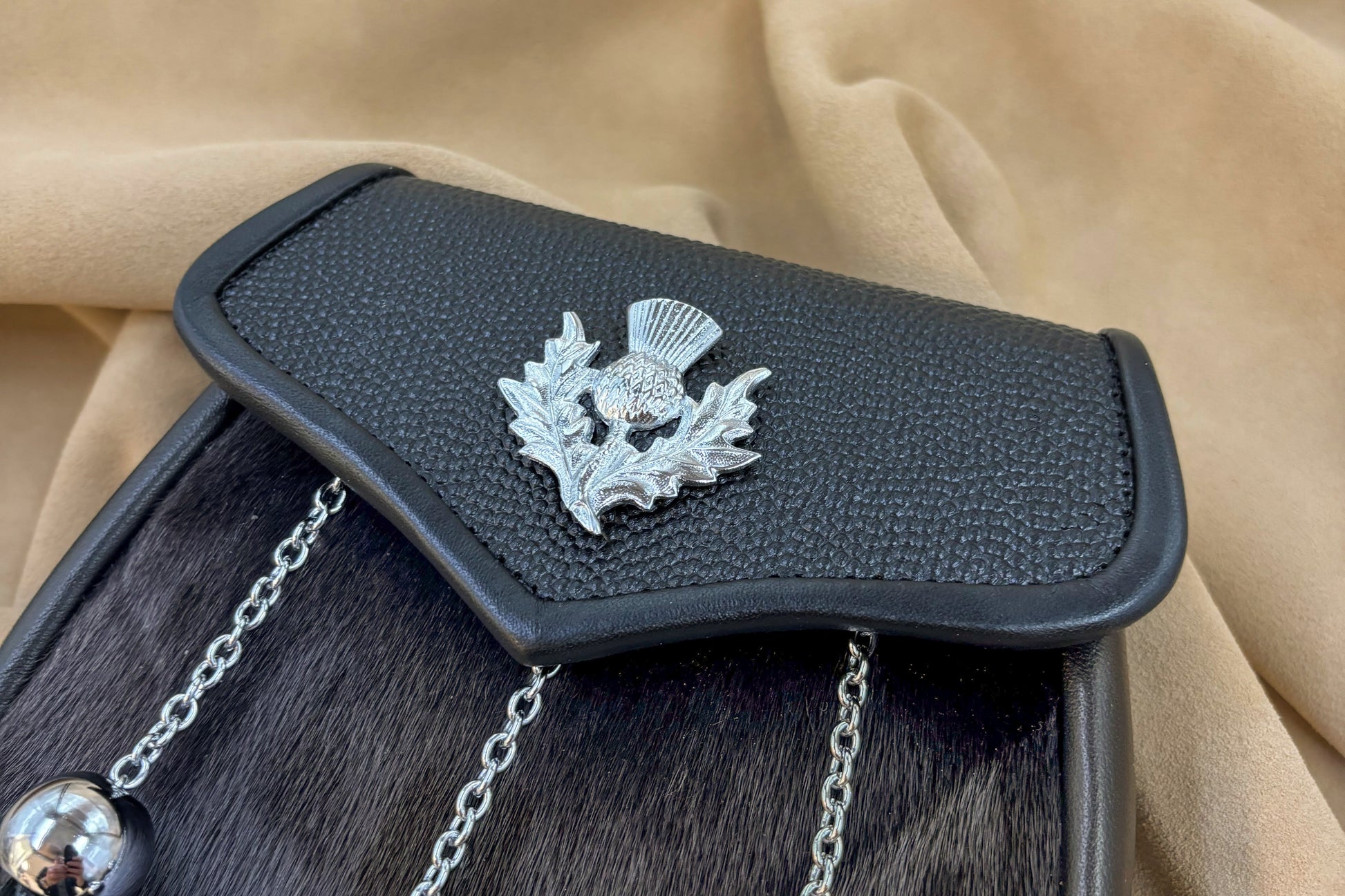 Black pebbled leather and seal sporran with nickel thistle hardware
