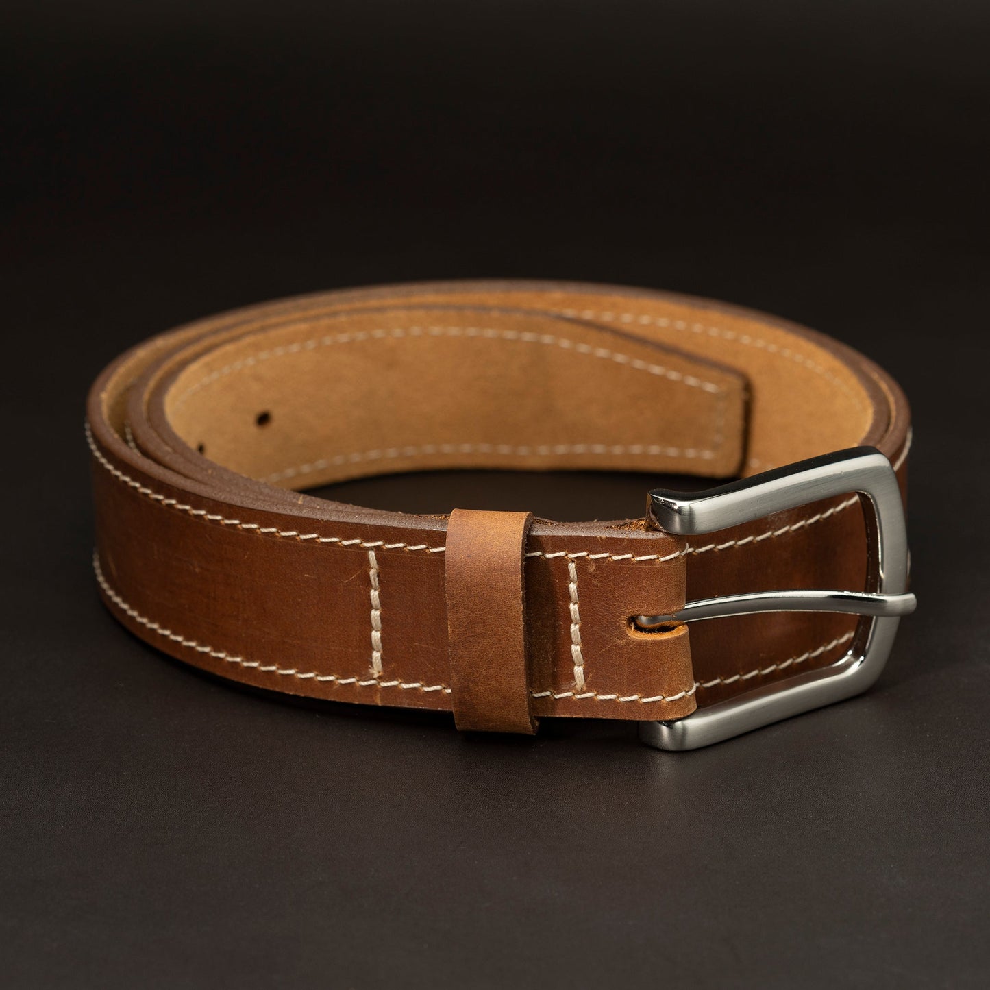 Medium brown belt with nickel buckle and light stitching