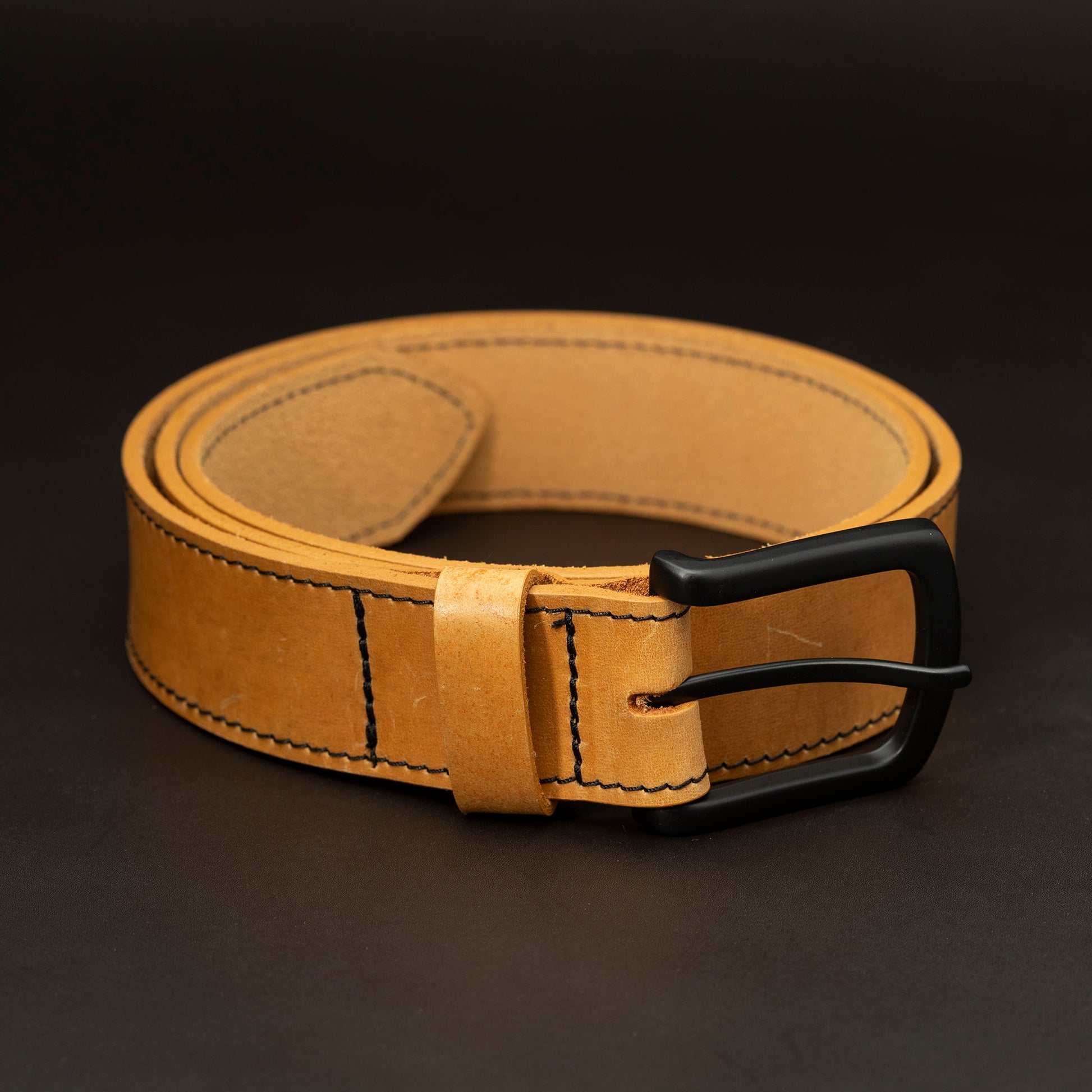 Russet leather belt with black buckle and dark stitching