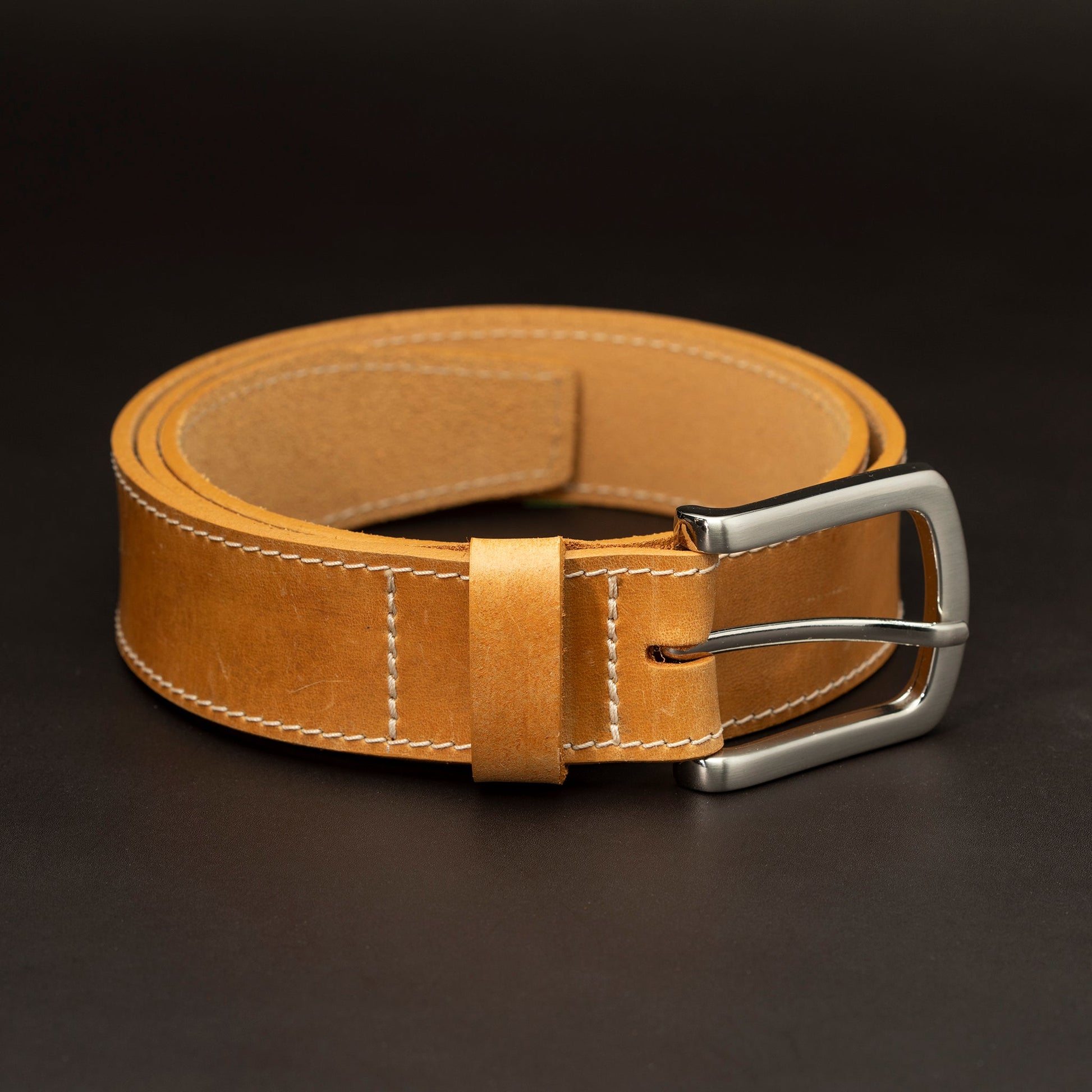 Russet leather belt with nickel buckle and light stitching