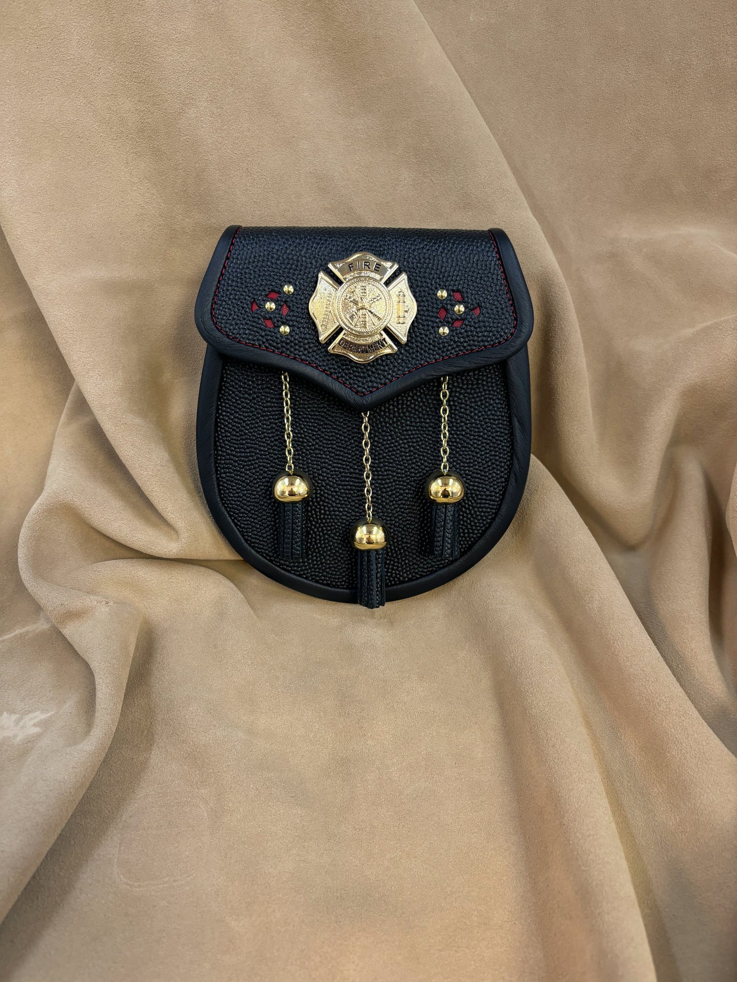 Black pebbled leather sporran with gilt fire crest and hardware, red stitching